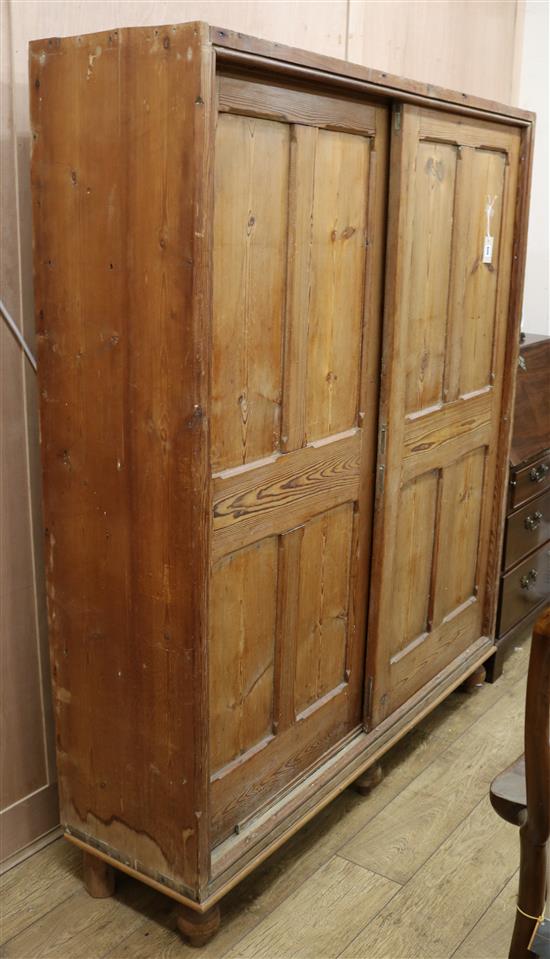 A Victorian pitch pine cupboard fitted sliding doors, W. 150cm